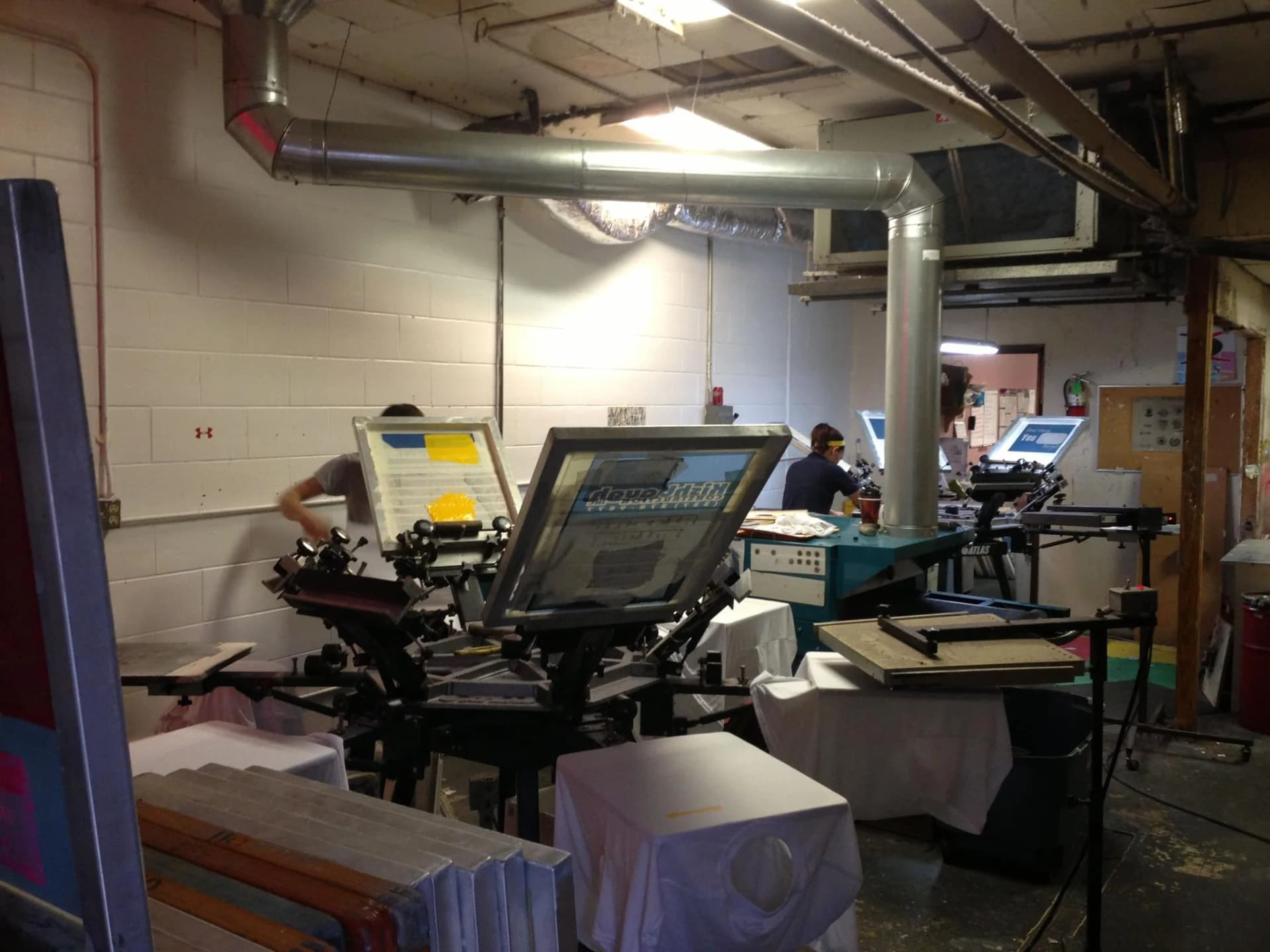 Multi-station screen printing press on the production floor at Perfect Fitz in Broussard LA