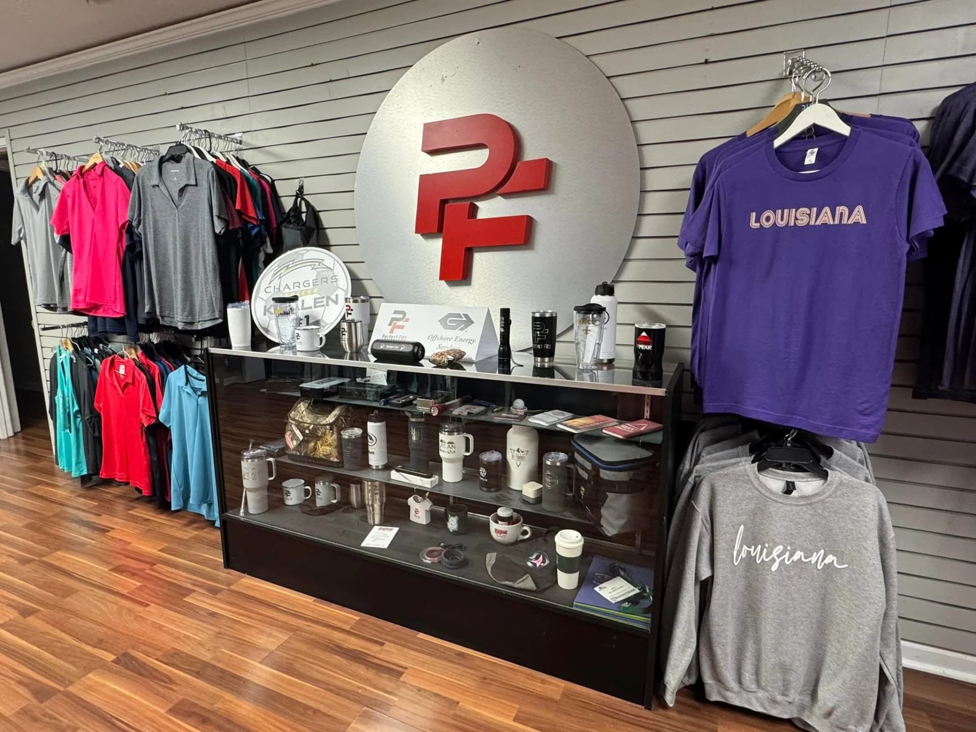 Custom branded apparel and promotional items on display at Perfect Fitz