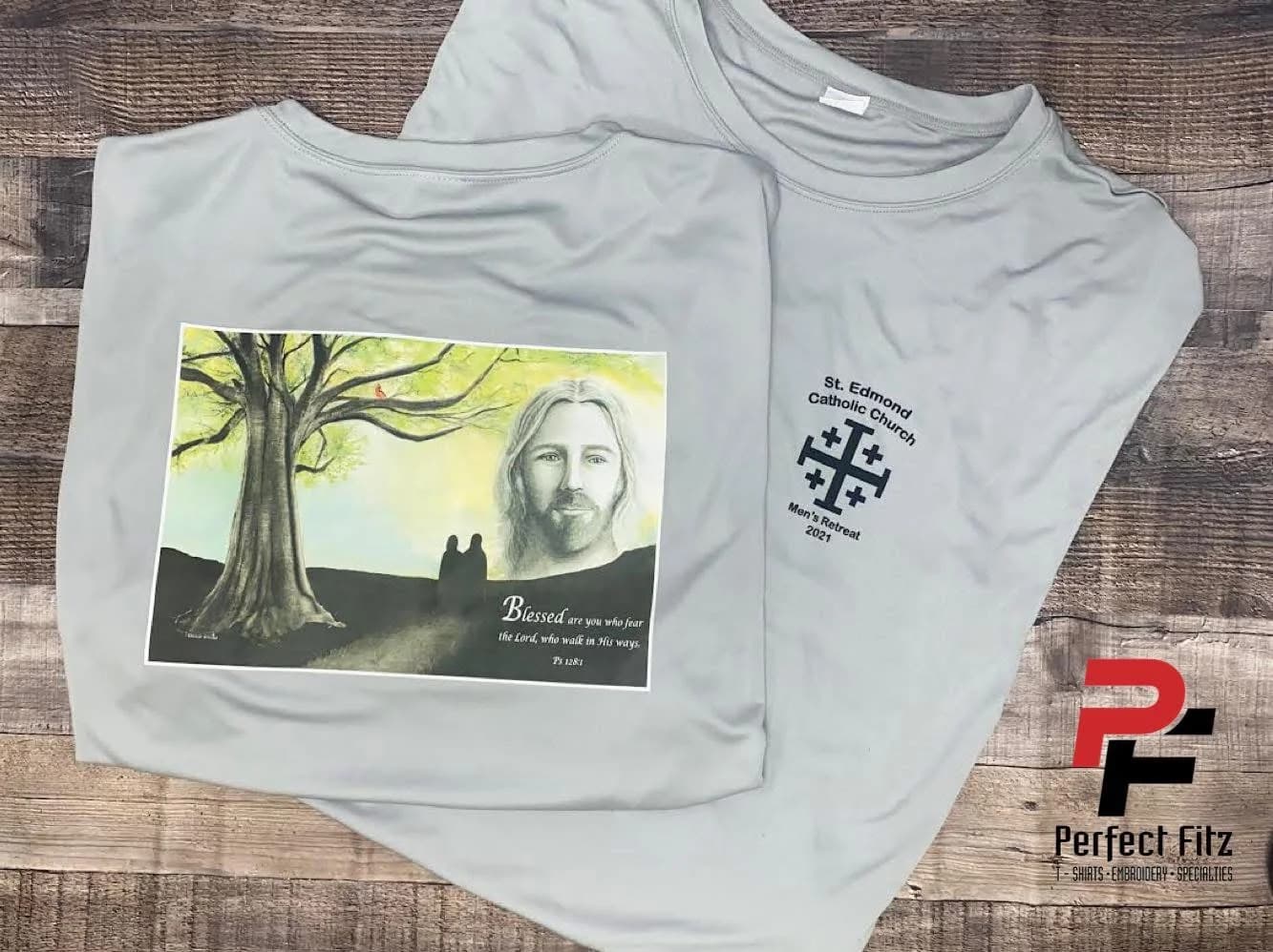 Two light grey t-shirts for St. Edmond Catholic Church Men's Retreat, one with a DTF print and one with embroidery